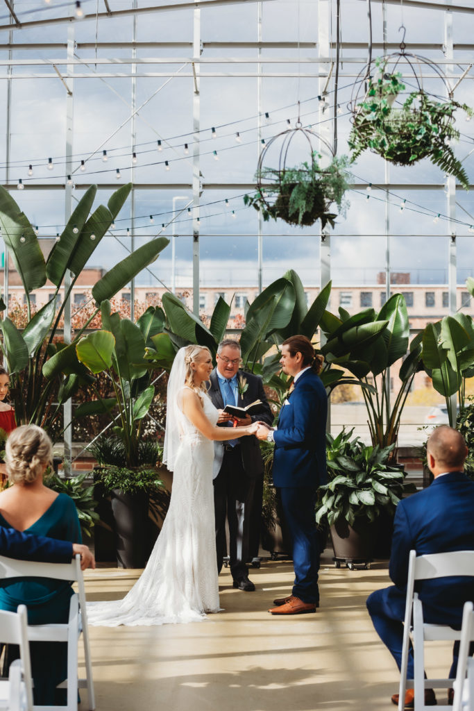 couple during wedding ceremony in a greenhouse at downtown market